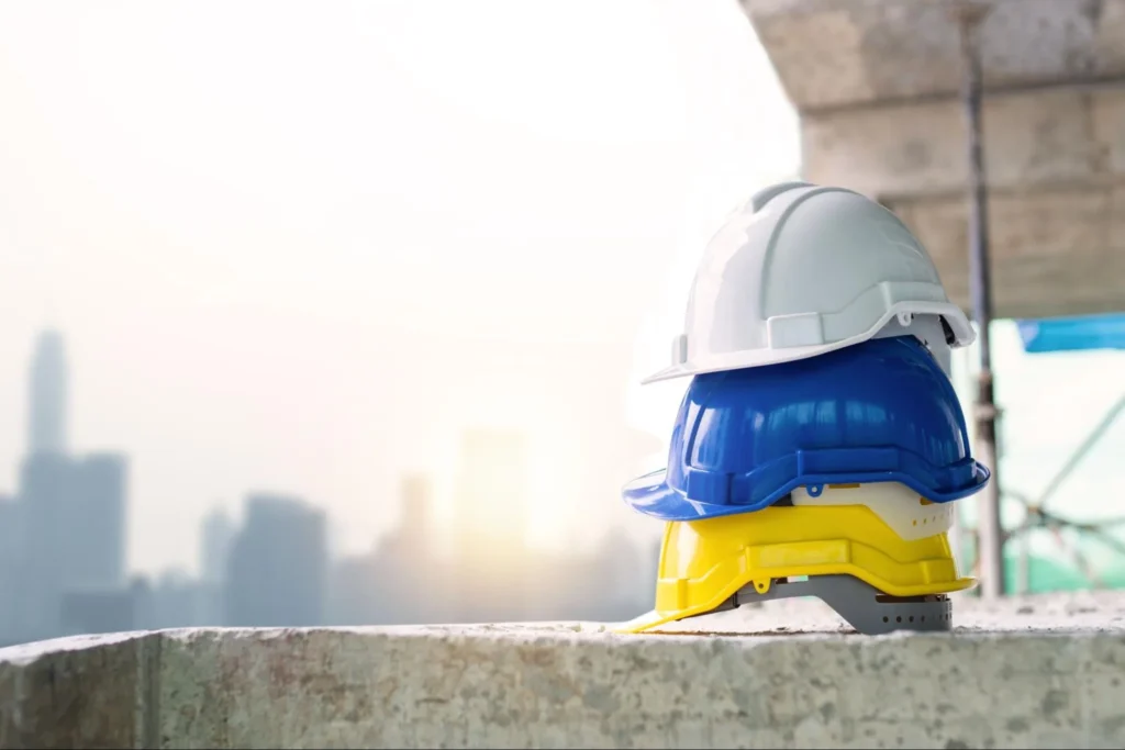 Construction hard hats stacked project site skyline